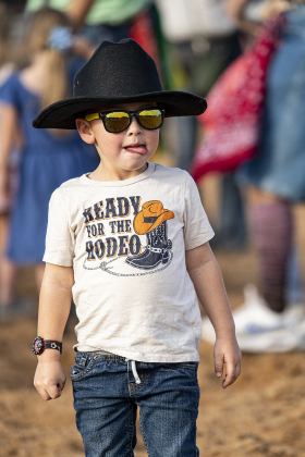 Hux Eden, 3, holds onto coins he gathered during the Nickel Scramble for ages 5 and under.