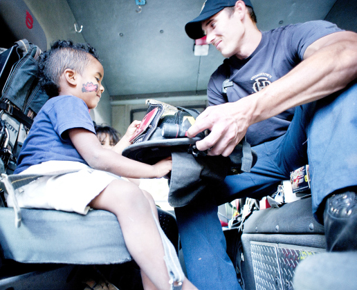 Isaiah Adams, 3, and his sister Ebony, 6 (behind him) get to sit in a fire engine and visit with Georgetown firefighter Jason Jeffery during National Night Out activities October 2, 2012. This was at a party on West 18th Street in Georgetown, in front of the Boys and Girls Club and the Georgetown Housing Authority, one of several party locations throughout the city. SUN ARCHIVE
