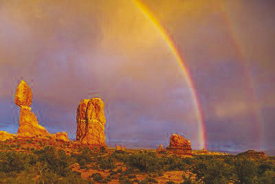Glenn Rudd’s “Balanced Rock Rainbow” captures the image of a double rainbow after thunderstorms in the Arches National Park.