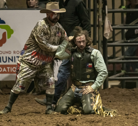 Saddle Bronc rider Brian Preston of College Station, right, is assisted after a rough fall from his horse.