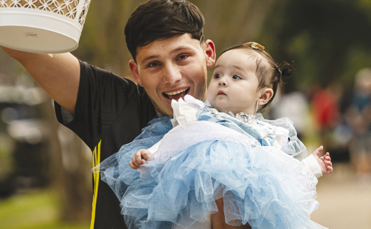 Sebastian Aguilar with his 8-month-old daughter Paulina trick-or-treat on Halloween night along Main Street in Old Town Monday, October 31.
