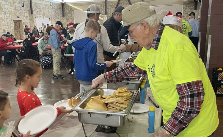 Rotary members serve guests a hearty Santa breakfast of pancakes and sausage December 17. Breakfast proceeds serve area youth programs. (Courtesy Georgetown ISD)