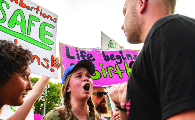 Abortion rights advocate Britt Donohoo, facing camera, argues her view with John (first name only given), a member of Georgetown's Covenant Bible Church during an abortion rights demonstration held at the square  on Sunday, July 10. (Photos by Andy Sharp)