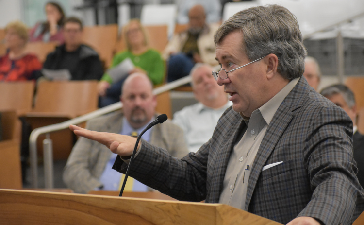 Demographer Bob Templeton spells out how high interest rates are slowing home sales during Georgetown ISD’s Monday, December 12, board meeting.  (Photo by Katherine Anthony)