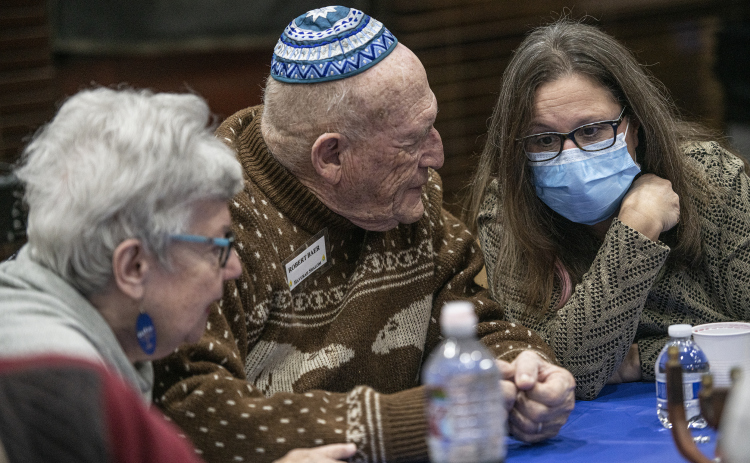 Robert Baer, center,  and his wife Linda, left, chat with Leila Liberman during a Sun City gathering of Congregation Havurah Shalom on Sunday, December 18, the first night of Hanukkah. (Photos by Andy Sharp)