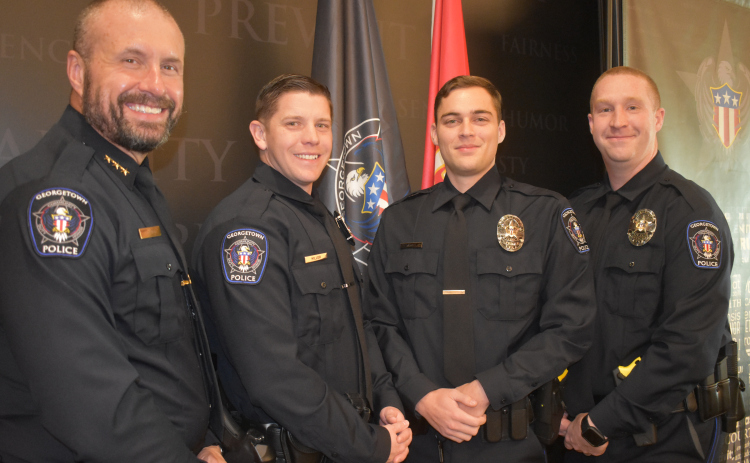 Georgetown Police Department Chief Cory Tchida, left, congratulates new officers sworn in Thursday. From left, they are Caleb Miller, Dakota Norwood and Dylan Wright.