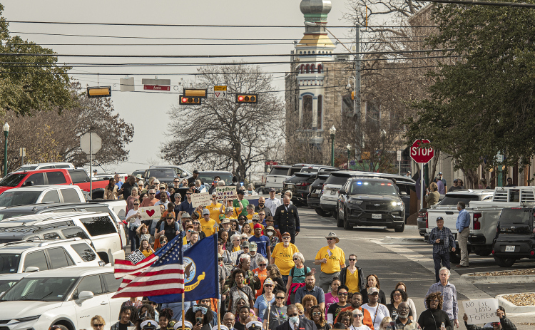 Marchers make their way along Seventh Street in Georgetown during the Dr. Martin Luther King, Jr. holiday celebration march from the square Monday,  January 16. The march was followed by a service at Macedonia Baptist Church. (Photos by Andy Sharp)
