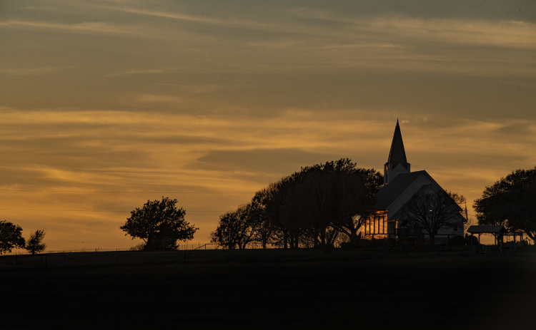 The last rays of the day’s sunlight fall on Prince of Peace Lutheran Church during the last week of 2022. The church is located on County Road 417 northwest of Taylor.  (Andy Sharp)
