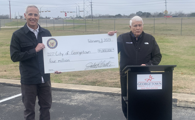 Representative John Carter, right, presents $4 million in federal funding to Georgetown Mayor Josh Schroeder Friday, February 3. The money will be used to expand FM 971 from Gann Street to SH 130. (Photo by Brigid Cooley)