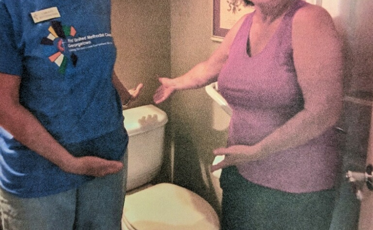 Group members install a toilet at a house that needed repairs. This is one of many tasks Georgetown Helpers is capable of completing. (Courtesy  Georgetown Helpers)
