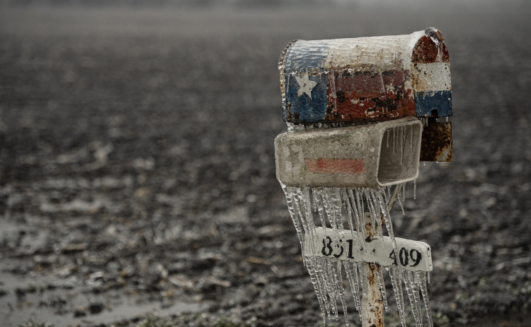 A Texas-themed mailbox is covered in ice along County Road 409 on Wednesday, February 1. (Photo by Andy Sharp)
