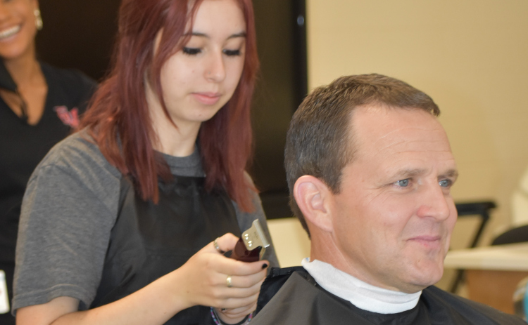 Georgetown ISD superintendent Fred Brent gets a haircut in October 2021 at the East View High School cosmetology lab. The facility was named after Sport Clips founder Gordon Logan and his family in recognition of their financial support for the program.  Photo by Katherine Anthony