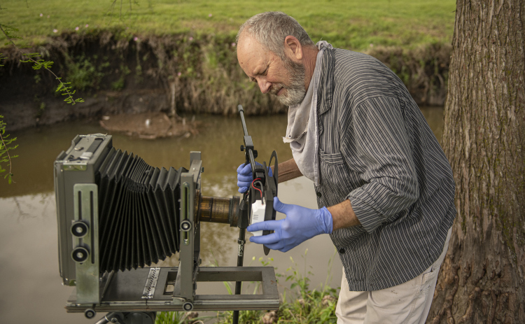 Georgetown photographer Tom Cavness is pictured at Bull Branch Park on Sunday, April 9, as he continues to master the 19th Century technique of wet plate collodion photography.   With him on this morning was a 1933 8x10 view camera manufactured by Burke and James. Photos by Andy Sharp