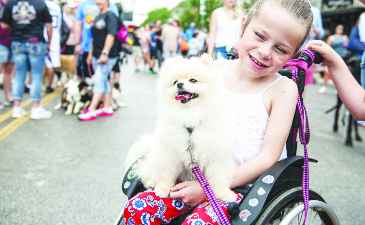 8-year-old Nicole Loyo was joined by Frozen, her 3-year-old Pomeranian,  at  the Red Poppy Festival's Popp Pup Parade, held in downtown Georgetown on Sunday, April 24, 2022.
