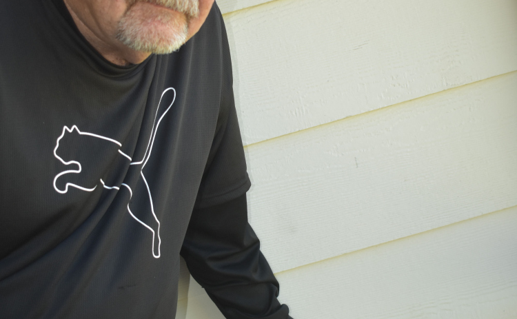 Sun City homeowner Kirk Kelley points to the hole in his porch wall made by a bullet of unknown origin. Photo by Katherine Anthony