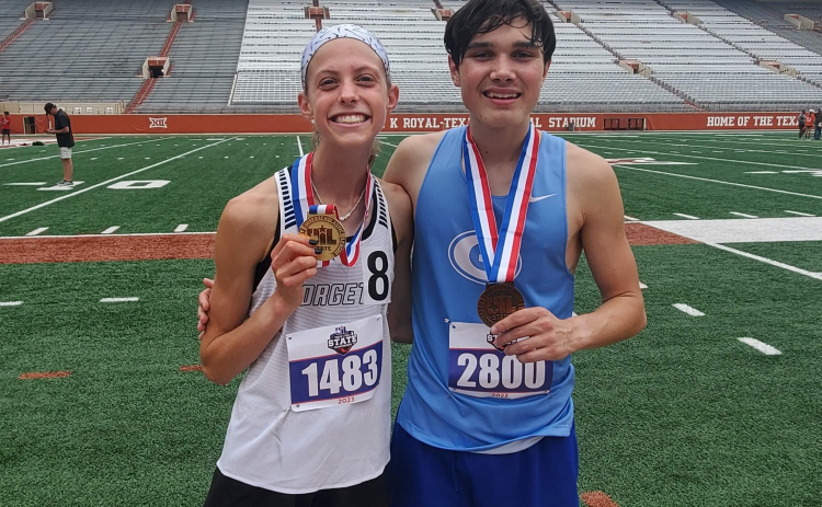 Mckenzie Bailey, who placed first in the girls 3,200 meter and third in the girls 1,600, stands with Joseph Wienen, who finished third in the boys 3,200 meter event.
