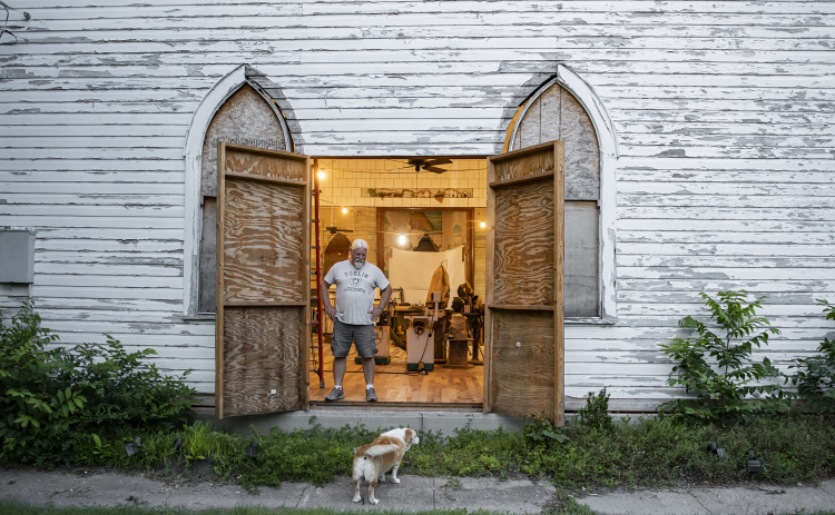 Robert Halstrom and his dog Ladybug relax near day's end at what was once Granger United Methodist Church on Monday, May 22.  Halstrom and his wife Joanne bought the circa 1904 church in 2019.  The project has continued since then, but  then Joanne was dealt a  a life-altering accident in March  2022.  The project has been put on hold for months, but slowly, Halstrom is back at work. Photos by Andy Sharp
