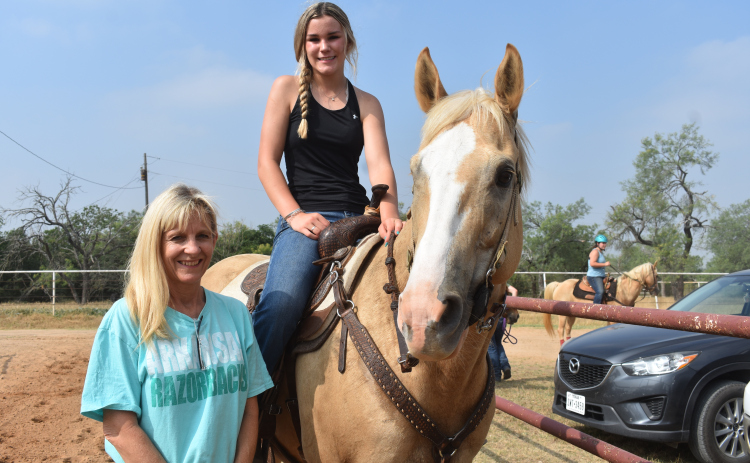 Windsong Farm co-owner Kelly Clayman, left, stands with new Texas State Champion Jaycee Ferguson. She is riding her horse, Izzy. Photo by Katherine Anthony
