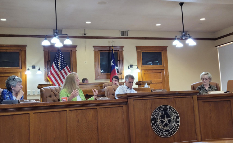 Williamson County Commissioners and County Judge Bill Gravell debate over an agenda item at Commissioner’s Court June 27. Photo by Nalani Nuylan.