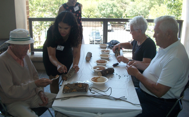 Volunteers and staff from A Gift of Time help Camille’s Memory Café participants build bird feeders May 19 on a deck outside Georgetown Public Library.