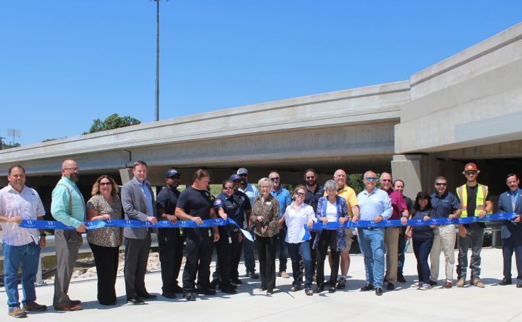 At the ribbon cutting, from left, were Oscar Salazar-Bueno, Whit Friend, Christen Eschberger, Scott Haywood with the Sam Bass Fire Department, Steven Shull, Precinct 3 Commissioner Valerie Covey, Tracy Cooper, Joelle Rosentswieg, William Sherwood, Precinct 1 Commissioner Terry Cook, Kim Filiatrault, Michael Tucker, Ken Reifschlager, Steven Waters, Janet Rubiano, Nester Rubiano, Aaron DeNucci, Richard Ridings.