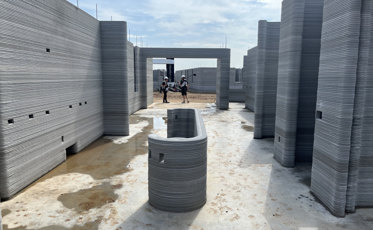 A living room and kitchen area under construction at the new 3D printed community in Wolf Ranch by ICON and Lennar Homes. Photos by Abbey Archer
