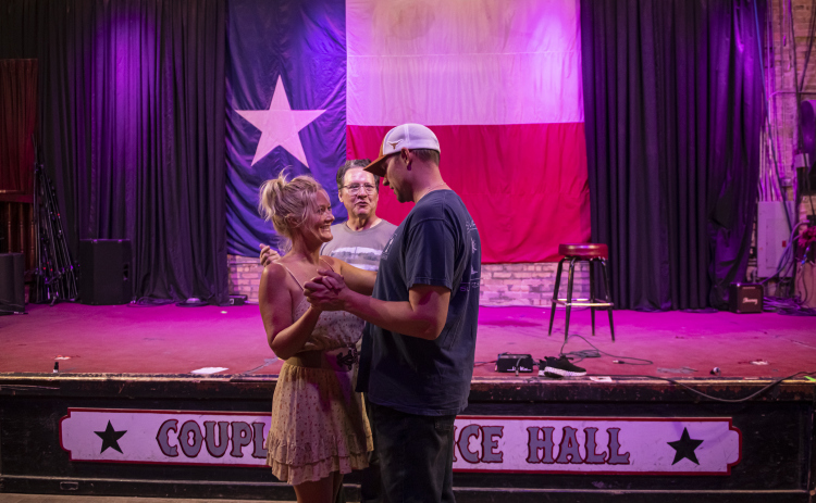 Russell Kinder,  center, owner (with his wife Erika)  of Coupland Dancehall, gives directions to Heather Humphrey and Eric Psencik.