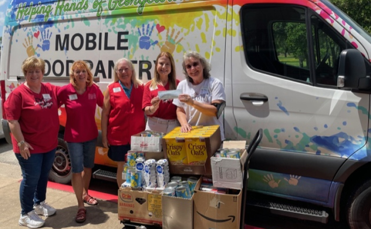 Pictured, from left, are Georgetown Area Junior Forum Members Jane Miller, Amanda Eisner, Anne Bustos and Diana Underwood, and Helping Hands of Georgetown staff member Cara Skinner. Photos courtesy the Georgetown Area Junior Forum.