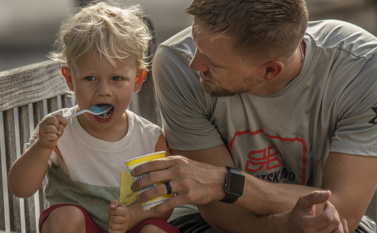 2-year-old Landon Kaliszewski enjoys a frozen iced treat with his dad Adam Kaliszewski.
