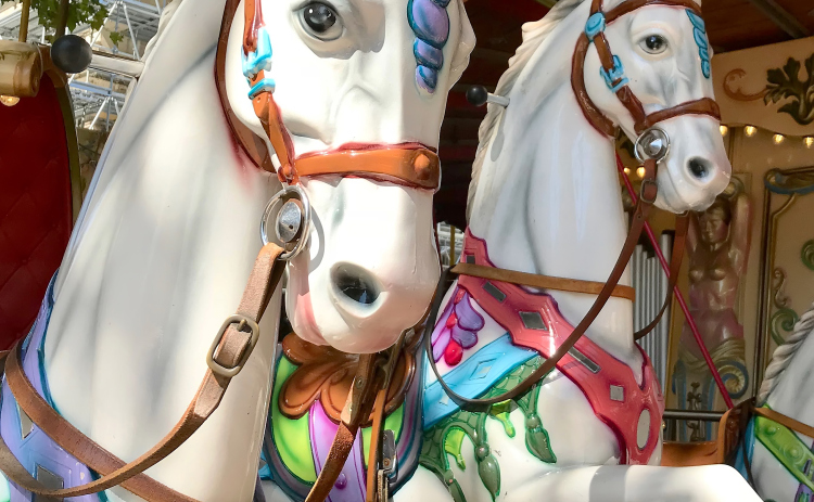 “Childhood Happiness” by Ellen Greeney is included in the current exhibit at Downtowner Gallery through September 8. The image captures an antique carousel in Avignon, France.