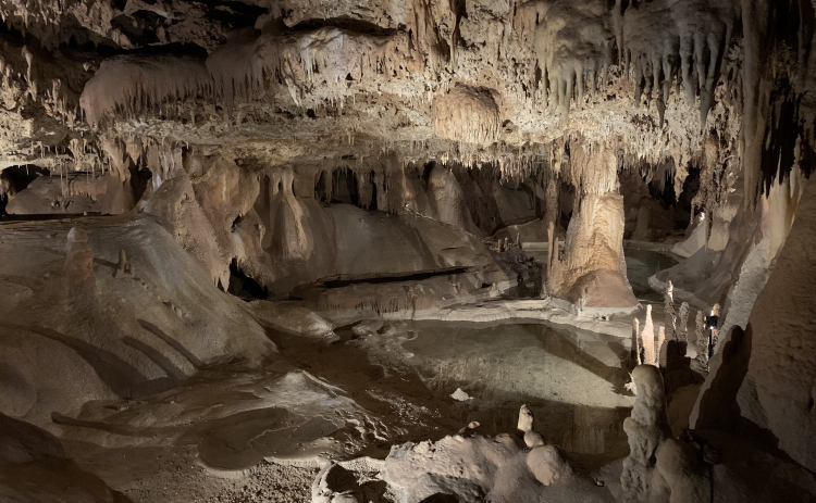 The caverns within the cave feature a variety of rock types and water pools.