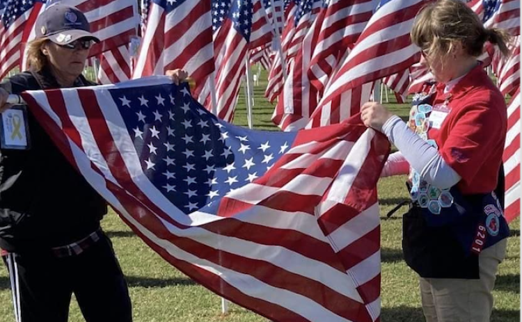 Volunteers help fold an American flag. (Photo from Jeanne Cox)