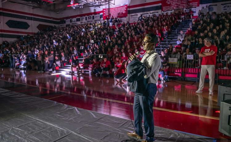 New Superintendent Devin Padavil addresses teachers and students during Tuesday's convocation. A power outage left them in darkness at the East View High School gymnasium, and he had to end the event early. Photo by Andy Sharp.