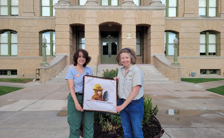 Texas A&M Public Information Officers Leslie Auriemmo (Left) and Besty Coffee (right) were walking on Georgetown Square sharing tips on how to prevent wildfires on August 10.  Photo by Nalani Nuylan.