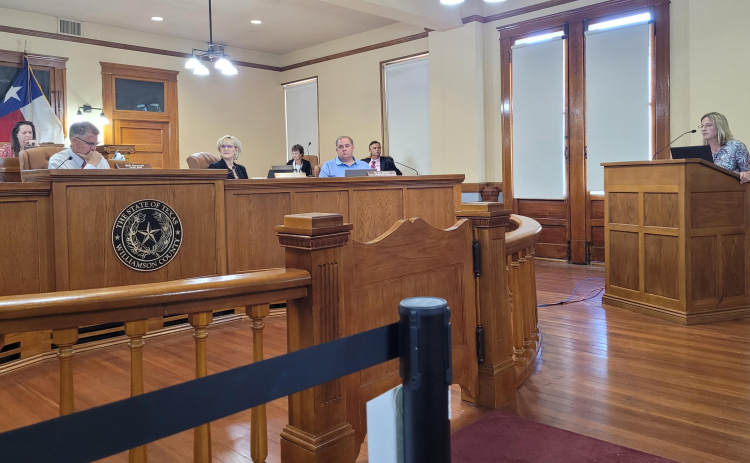 Williamson County Auditor Julie Kiley answers questions about billing the non-county dispatch services at the August 1 Commissioners Court meeting. Photo by Nalani Nuylan.