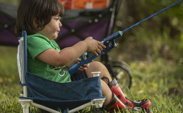 2-year-old Emma Richardson concentrates on her angling skills.