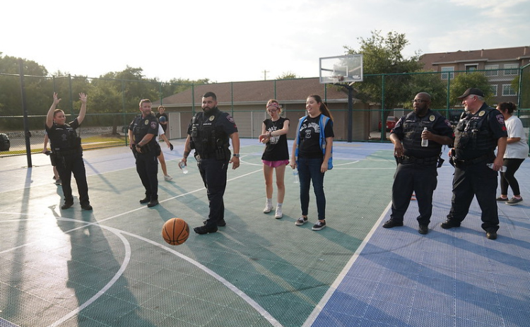 Cedar Park Police officers play basketball at a Cedar Park apartment complex during the department’s National Night Out on August 1, 2023. Photo Courtesy of Cedar Park Police.