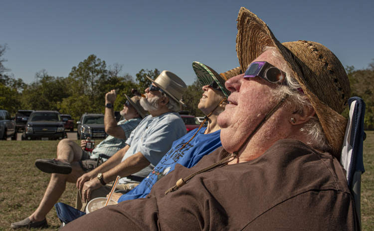 (Front to back) Keri Davis, Vicki Goodrich, Vick's husband Robert Goodrich and Duane Davis (Keri's husband) watch the annular eclipse during a Saturday, October 14, 2023 gathering at Berry Springs Parks & Preserve,  hosted by Friends of Berry Springs Park.  An annular eclipse occurs when the moon gets between the earth and sun.  The eclipse's visibility was approximately 89% in the Austin area. Photo by Andy Sharp.