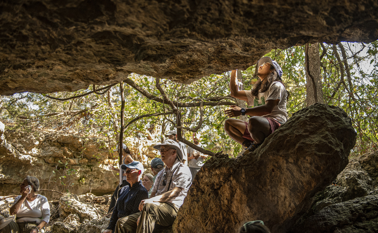 Jason Rodriguez looks over features of a limestone cave (one of several) at Pecan Springs Karst Preserve.