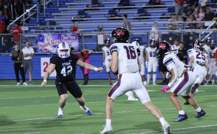 East View High School football quarterback Ty Blair tries to find an open player to pass the ball during the October 13 match against the Georgetown Eagles. Photo by Nalani Nuylan.