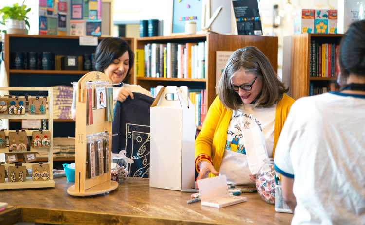 Jane Estes and Misty Adair organize shelves at Lark and Owl Booksellers.