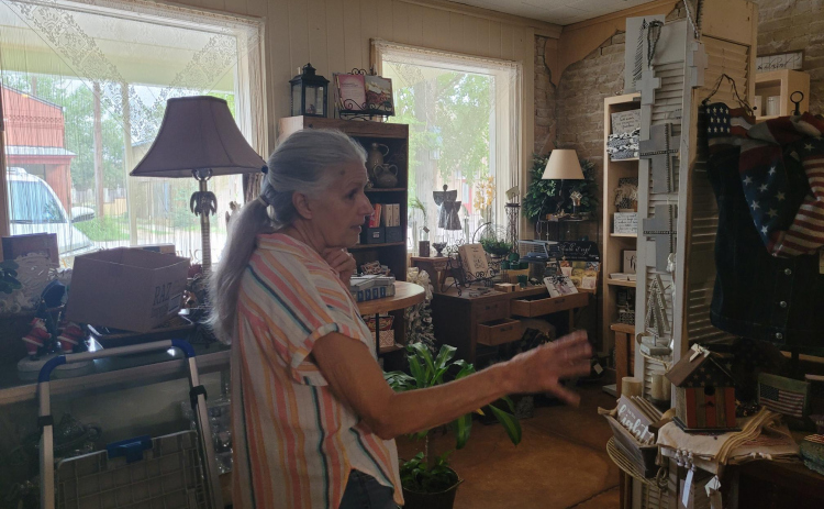 Debbie Wendeler gives a tour of the Fourth of July section of her gift shop. Originally the Bartlett post office, she gets the supplies for the store in Dallas. Photo by Nalani Nuylan.