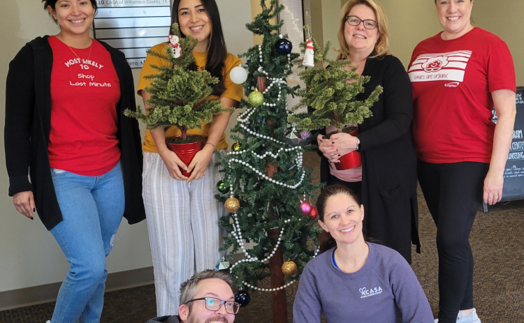 CASA of Williamson County office staff poses for a holiday photo. From left to right font is James Arrington and Marissa Austin. In the back row, Bethany Lopez, Natalie De La Torre, Trish Garrett, and Wendy McRae.  Photo courtesy of Tina Clary.