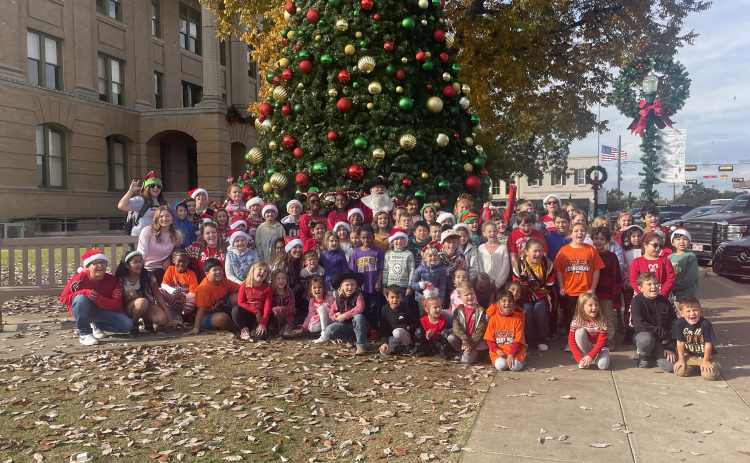A group of Liberty Hill students stand with Santa on the Square December 7.  Photo by Nicholas Cicale