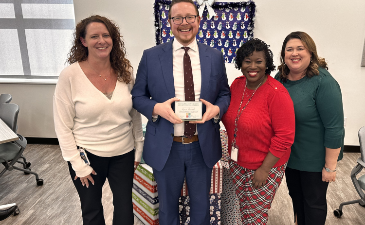Ryan Bownds, center, stands with Chief Executive Officer Kerrie Stannell, left, Director of Client Services Felicia Coleman, and Chief Program Officer Jennifer Deazvedo, right, of the Williamson County Children’s Advocacy Center. Photo courtesy of the Williamson County District Attorney’s Office.