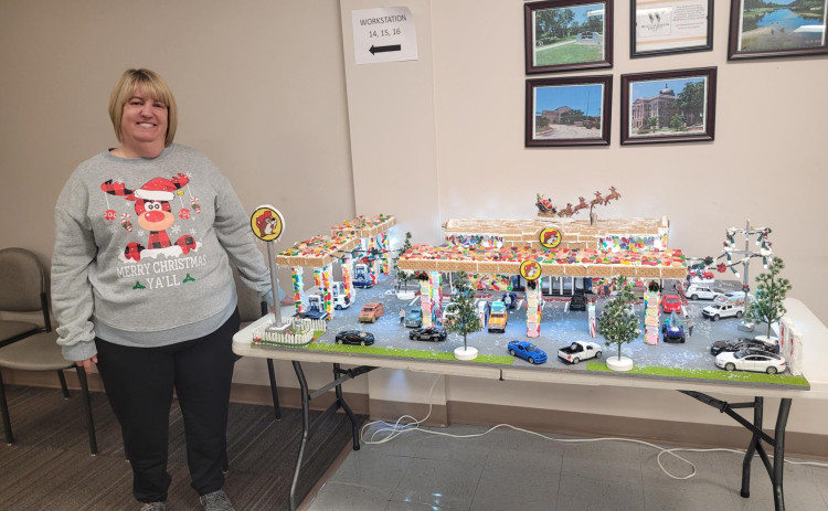 Williamson County Accountant Deanna Vaters stands with her Buc-ee's Gingerbread house in the County Tax Assessor’s office. She began preparing for the project in September. The display took her three days to build.