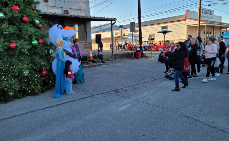 Jarrell residents wait in line to have their children take photos with Anna, Elsa and Olaf in front of Jarrell’s Christmas Tree during A Very Merry Jarrell on December 16.