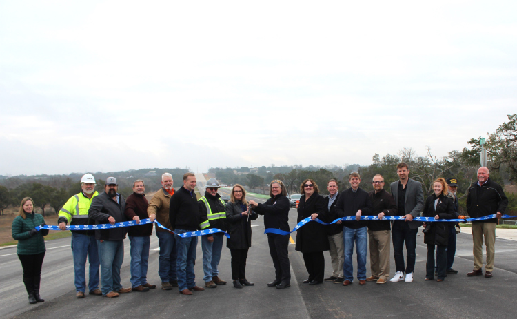 Celebrating the completion of County Road 258 are, from left, Ragan Riggs, Bruce Thurin, Steven Shull, Steven Widacki, John Nichols, Liberty Hill ISD Superintendent Steve Snell, Precinct 2 Commissioner Cynthia Long, Kathy Major, Christen Eschberger, Chase Myers, Eddie Church, Randy Ehresman, Adam Pfeiffer, Heather Sulaica, Estes Major, and Joe Bland. Photo courtesy of Williamson County.
