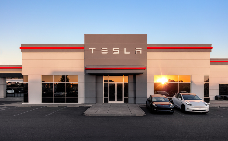 The sun sets on a Tesla store. Photo courtesy of Tesla Inc.