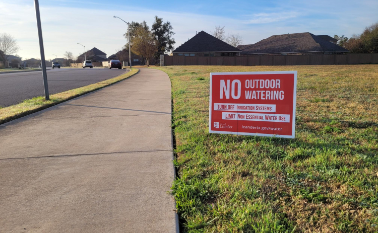 A yard sign tells residents of Cold Springs in Leander to practice Phase 4 water restrictions in preparation of the BCRUA pipeline shutoff. Photo by Nalani Nuylan.